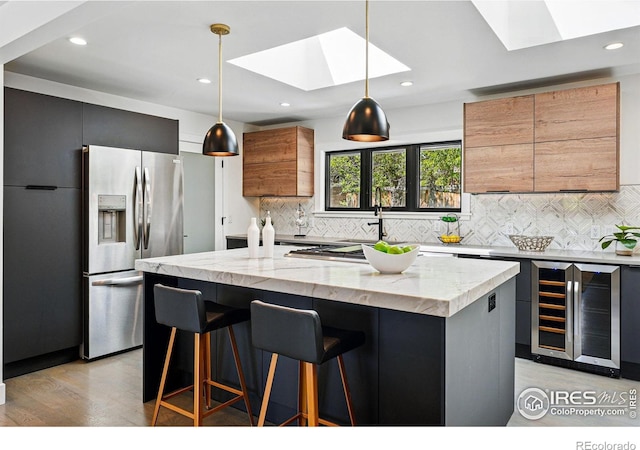 3275 19th St, Boulder, CO 80304 - kitchen with beverage cooler, stainless steel fridge with ice dispenser, a skylight, light wood-style floors, and recessed lighting