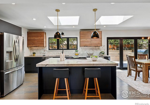3275 19th St, Boulder, CO 80304 - kitchen featuring stainless steel fridge, a skylight, modern cabinets, brown cabinetry, and recessed lighting
