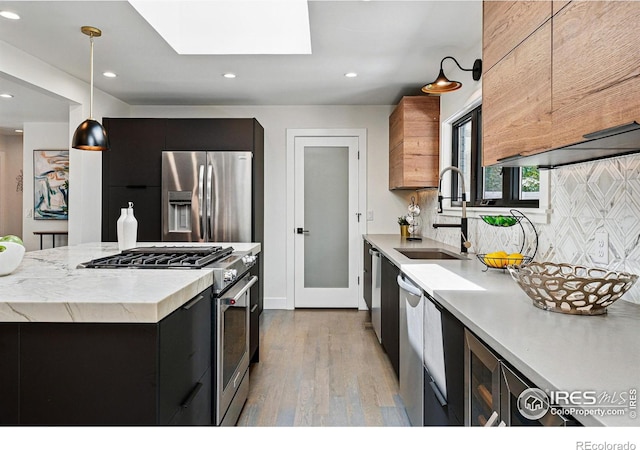3275 19th St, Boulder, CO 80304 - kitchen with appliances with stainless steel finishes, light wood finished floors, dark cabinets, recessed lighting, and tasteful backsplash