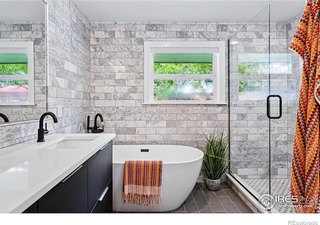 3275 19th St, Boulder, CO 80304 - bathroom with vanity, a freestanding tub, tile walls, a shower stall, and tile patterned flooring