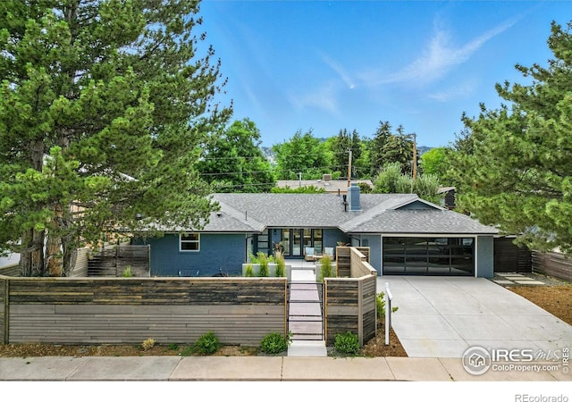 3275 19th St, Boulder, CO 80304 - view of front of property featuring a fenced front yard, driveway, a garage, a gate, and a shingled roof
