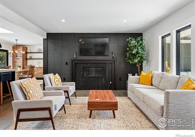 3275 19th St, Boulder, CO 80304 - living area featuring light wood-type flooring, a chandelier, a glass covered fireplace, recessed lighting, and an accent wall