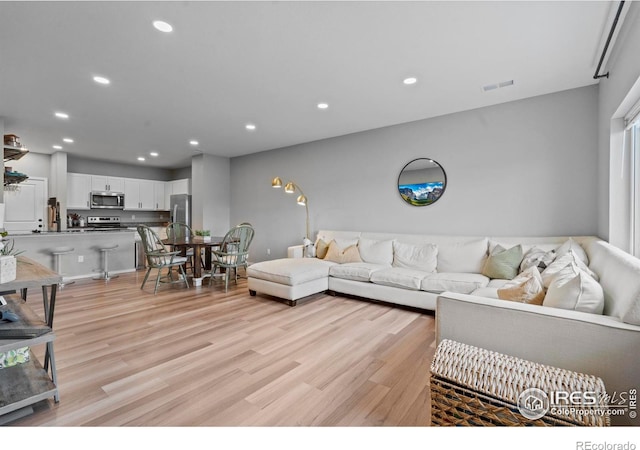 3644 Ronald Reagan Ave, Wellington, CO 80549 - living area with light wood-style floors and recessed lighting