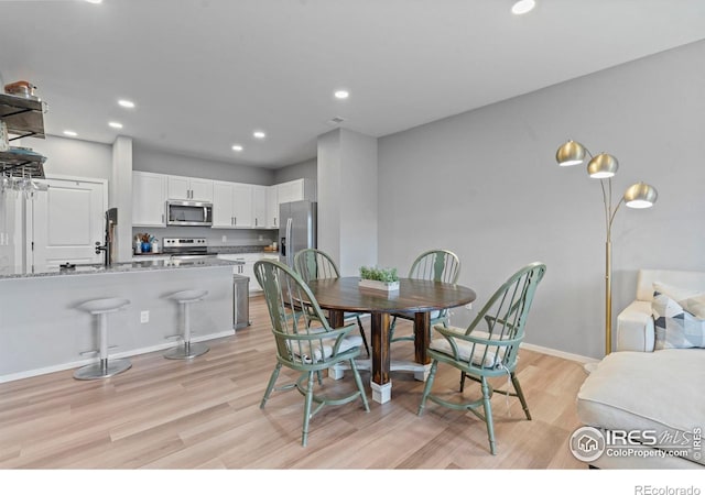3644 Ronald Reagan Ave, Wellington, CO 80549 - dining space featuring light wood-type flooring and recessed lighting