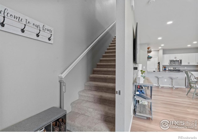 3644 Ronald Reagan Ave, Wellington, CO 80549 - staircase featuring wood finished floors and recessed lighting