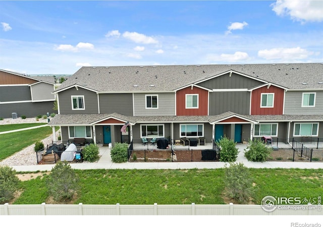 3644 Ronald Reagan Ave, Wellington, CO 80549 - view of front of house featuring a patio, a fenced backyard, and a shingled roof