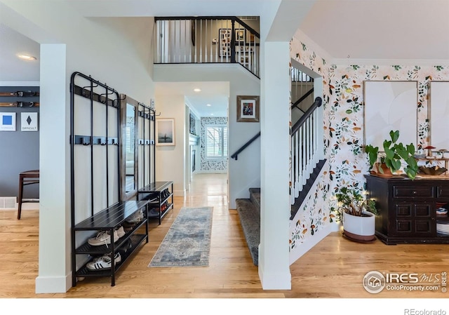 1405 Clover Creek Dr, Longmont, CO 80503 - entryway featuring stairs, wood finished floors, and wallpapered walls