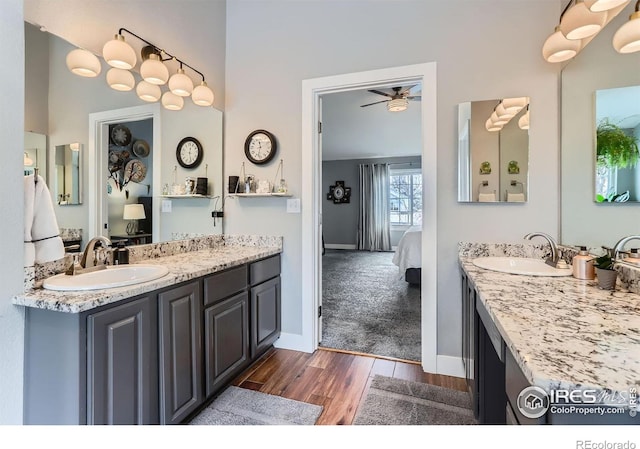 1405 Clover Creek Dr, Longmont, CO 80503 - ensuite bathroom with wood finished floors, a ceiling fan, and two vanities