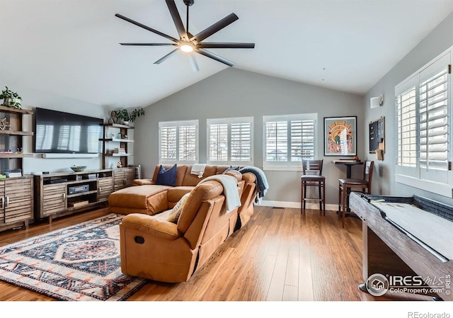 1405 Clover Creek Dr, Longmont, CO 80503 - living area featuring a ceiling fan, healthy amount of natural light, wood finished floors, and lofted ceiling