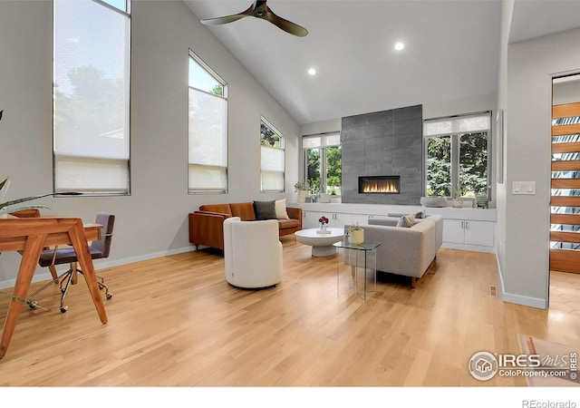 3470 16th St, Boulder, CO 80304 - living area with light wood-type flooring, recessed lighting, ceiling fan, a tiled fireplace, and high vaulted ceiling