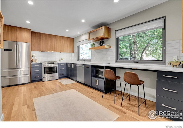 3470 16th St, Boulder, CO 80304 - kitchen featuring stainless steel appliances, light countertops, backsplash, recessed lighting, and brown cabinets