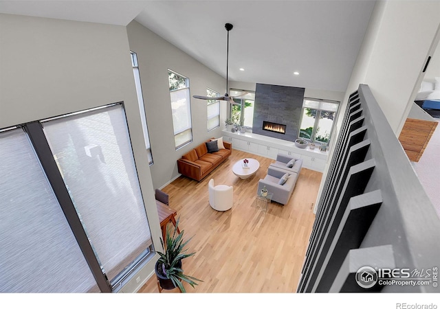 3470 16th St, Boulder, CO 80304 - living area featuring wood finished floors, lofted ceiling, healthy amount of natural light, a fireplace, and recessed lighting