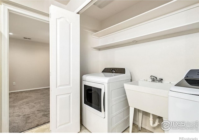 2502 Timberwood Dr Unit 104, Fort Collins, CO 80528 - washroom featuring washing machine and dryer and light carpet