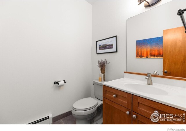 108 Lonestar Rd, Lyons, CO 80540 - half bath with a baseboard heating unit, vanity, and tile patterned floors