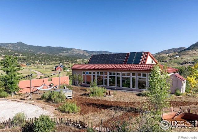 108 Lonestar Rd, Lyons, CO 80540 - back of house featuring a mountain view, solar panels, and a storage shed