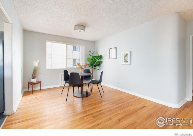 1100 Colorado Blvd Unit 305, Denver, CO 80206 - dining space with wood finished floors and a textured ceiling