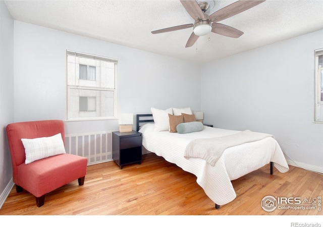 1100 Colorado Blvd Unit 305, Denver, CO 80206 - bedroom featuring wood finished floors, a ceiling fan, and a textured ceiling