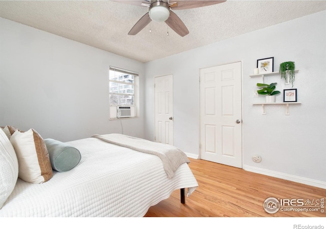 1100 Colorado Blvd Unit 305, Denver, CO 80206 - bedroom featuring light wood-style flooring, a textured ceiling, ceiling fan, and cooling unit