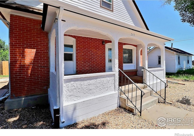 263 E 2nd St, Ault, CO 80610 - entrance to property featuring brick siding and covered porch