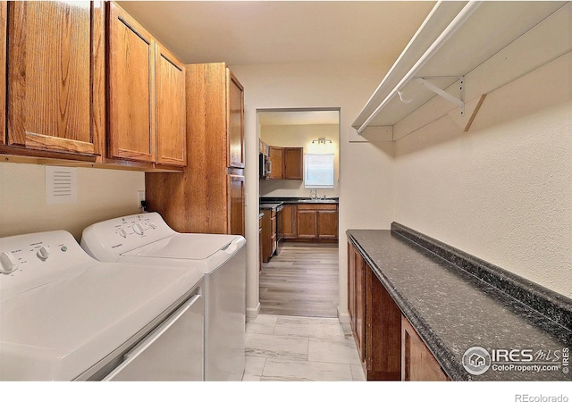 263 E 2nd St, Ault, CO 80610 - washroom featuring cabinet space and washer and dryer