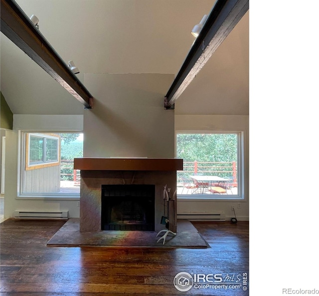 383 Evergreen Rd, Black Hawk, CO 80422 - unfurnished living room with a baseboard heating unit, lofted ceiling, wood finished floors, a fireplace, and plenty of natural light