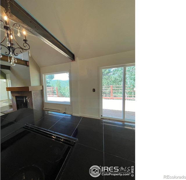 383 Evergreen Rd, Black Hawk, CO 80422 - kitchen featuring tile countertops, vaulted ceiling, a fireplace, a chandelier, and black range with electric cooktop