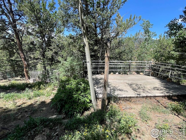 383 Evergreen Rd, Black Hawk, CO 80422 - view of yard featuring a wooden deck and a wooded view