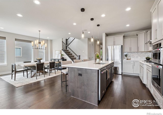3315 Heron Lakes Pkwy, Berthoud, CO 80513 - kitchen featuring appliances with stainless steel finishes, recessed lighting, a chandelier, tasteful backsplash, and light countertops