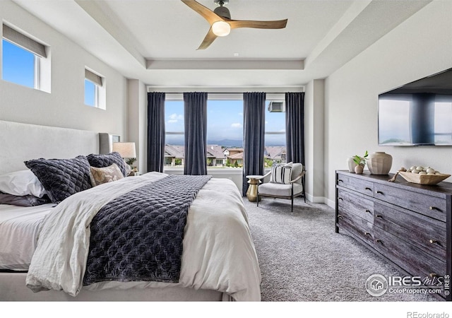3315 Heron Lakes Pkwy, Berthoud, CO 80513 - bedroom featuring a tray ceiling, carpet, and a ceiling fan