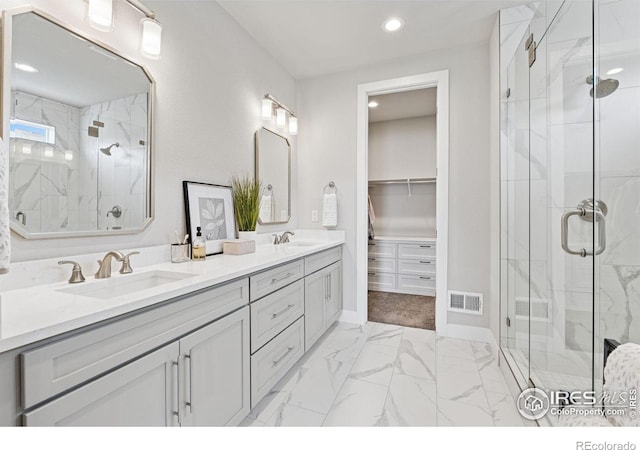 3315 Heron Lakes Pkwy, Berthoud, CO 80513 - bathroom featuring a marble finish shower, double vanity, marble finish flooring, recessed lighting, and a walk in closet