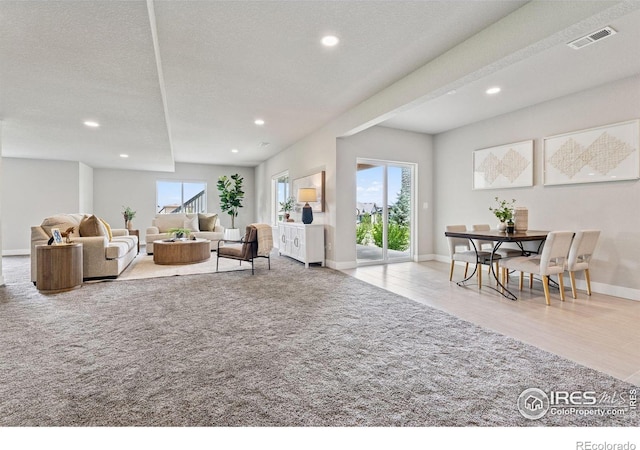 3315 Heron Lakes Pkwy, Berthoud, CO 80513 - living room featuring recessed lighting, wood finished floors, and carpet