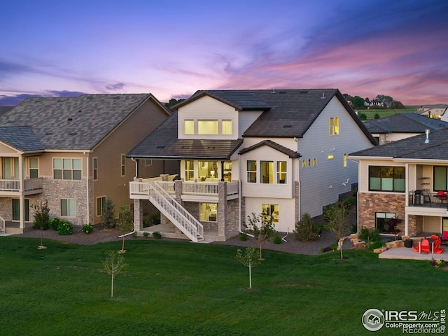 3315 Heron Lakes Pkwy, Berthoud, CO 80513 - back of property featuring stairway, a patio area, a yard, and a deck