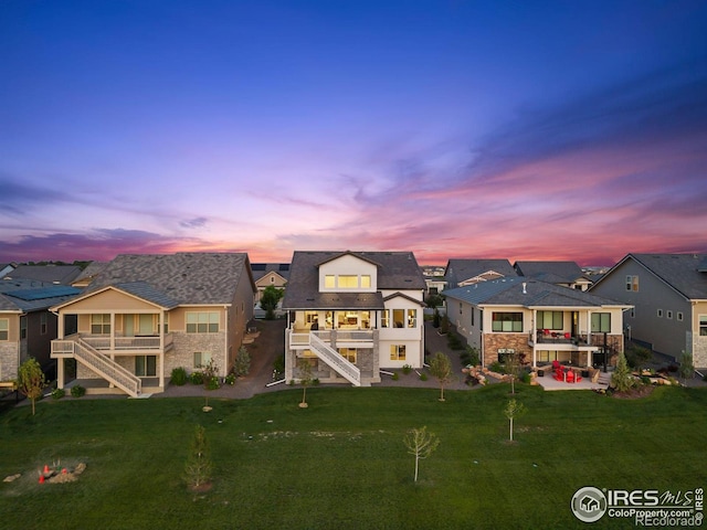 3315 Heron Lakes Pkwy, Berthoud, CO 80513 - back of house featuring stairs, a residential view, a balcony, a patio, and stone siding