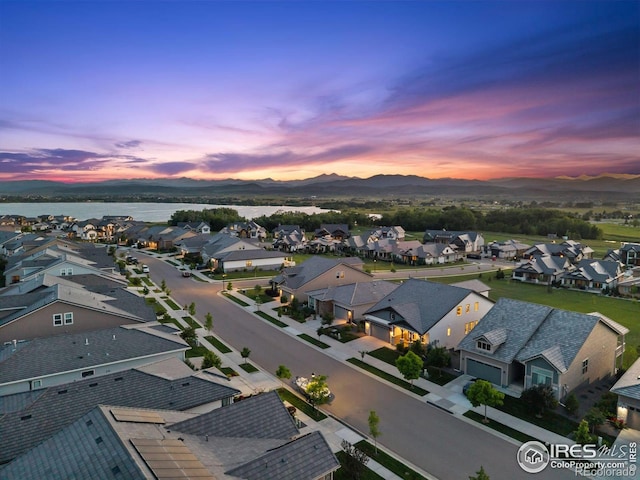 3315 Heron Lakes Pkwy, Berthoud, CO 80513 - aerial perspective of suburban area with a water and mountain view