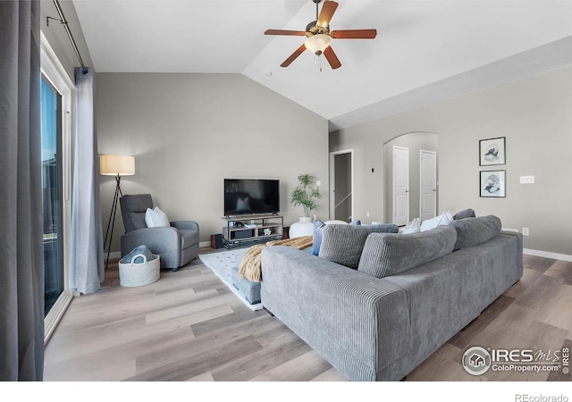 1384 S Growers Dr, Milliken, CO 80543 - living room with arched walkways, ceiling fan, wood finished floors, and lofted ceiling