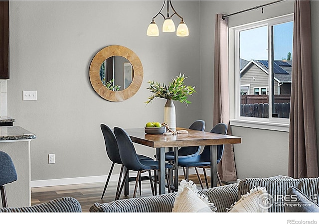1384 S Growers Dr, Milliken, CO 80543 - dining area featuring dark wood finished floors and baseboards