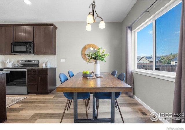1384 S Growers Dr, Milliken, CO 80543 - dining space with light wood-style floors and baseboards