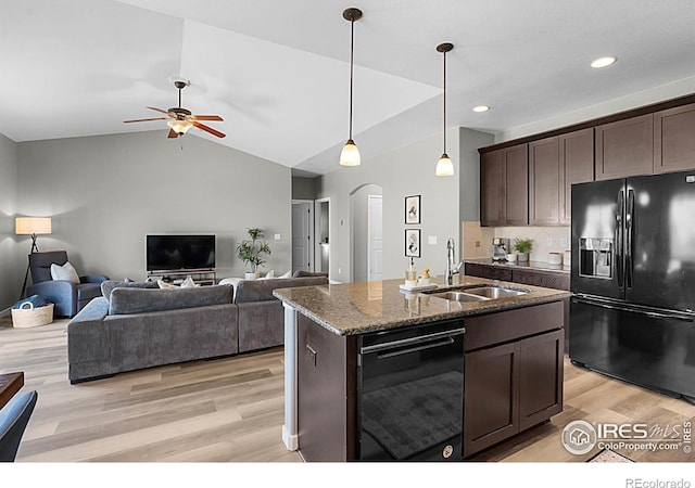 1384 S Growers Dr, Milliken, CO 80543 - kitchen with black appliances, arched walkways, dark brown cabinets, a ceiling fan, and light wood-style flooring