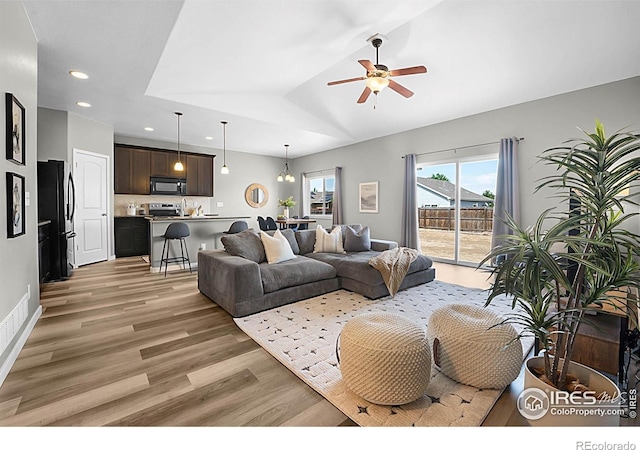 1384 S Growers Dr, Milliken, CO 80543 - living area featuring light wood-style flooring, ceiling fan, recessed lighting, and lofted ceiling