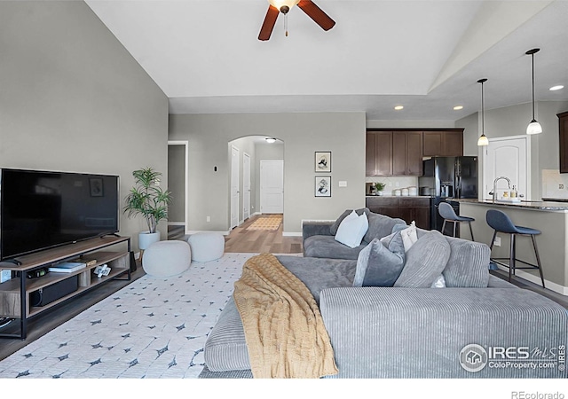 1384 S Growers Dr, Milliken, CO 80543 - living room featuring arched walkways, ceiling fan, vaulted ceiling, recessed lighting, and light wood-type flooring