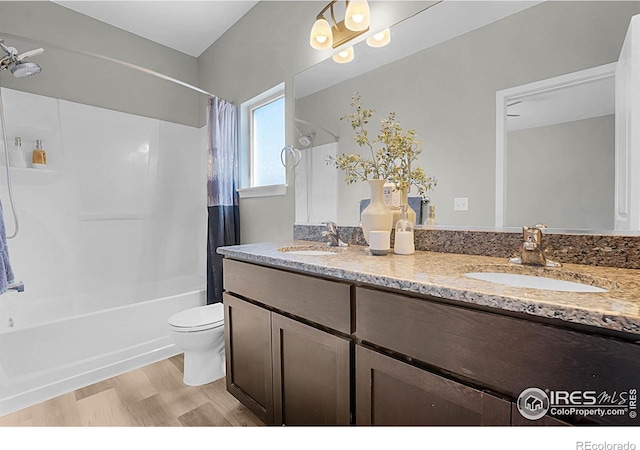 1384 S Growers Dr, Milliken, CO 80543 - bathroom with shower / tub combo, double vanity, and wood finished floors