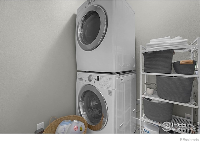 1384 S Growers Dr, Milliken, CO 80543 - washroom with stacked washing machine and dryer and a textured wall