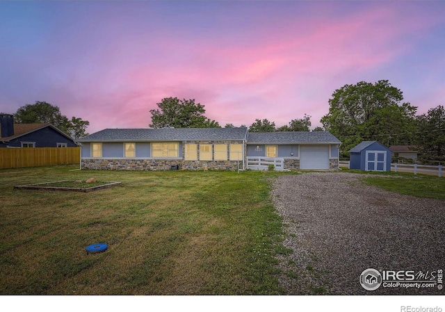 4331 Page Pl, Loveland, CO 80537 - single story home with stone siding, a storage unit, and gravel driveway