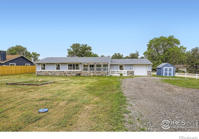 4331 Page Pl, Loveland, CO 80537 - ranch-style house with stone siding, a storage shed, gravel driveway, and a garage