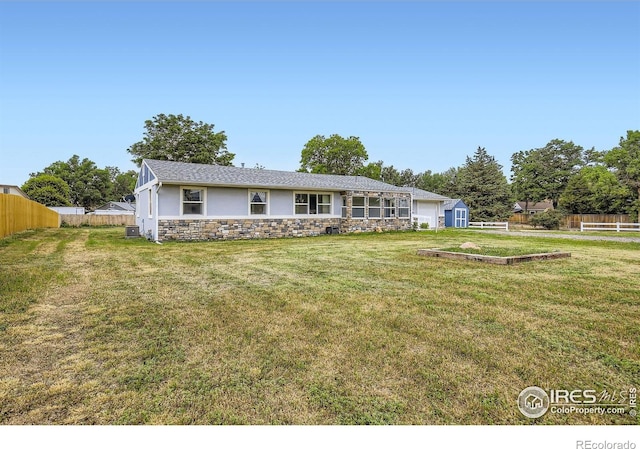 4331 Page Pl, Loveland, CO 80537 - ranch-style home with stucco siding, stone siding, a garage, and an outdoor structure