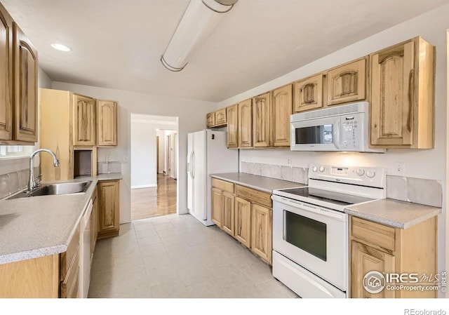 4331 Page Pl, Loveland, CO 80537 - kitchen with white appliances, light countertops, light brown cabinetry, and recessed lighting
