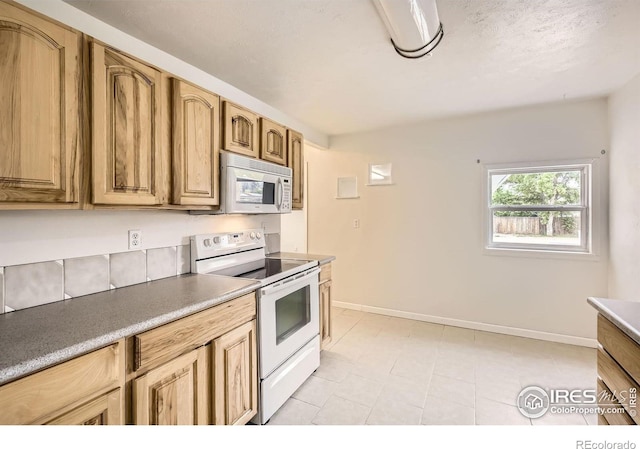 4331 Page Pl, Loveland, CO 80537 - kitchen featuring white appliances and light tile patterned floors