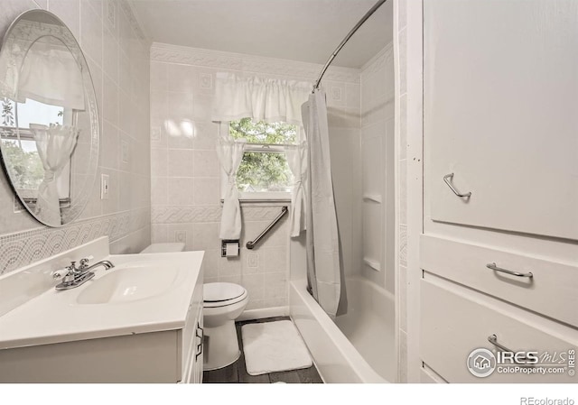 4331 Page Pl, Loveland, CO 80537 - full bathroom featuring vanity, shower / bath combination with curtain, and tile walls
