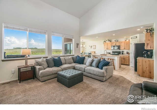 1103 Ibex Dr, Severance, CO 80550 - living room featuring a high ceiling, light carpet, and recessed lighting