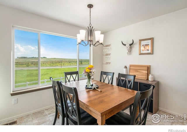 1103 Ibex Dr, Severance, CO 80550 - dining area with a chandelier and plenty of natural light